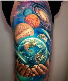 a man with tattoos on his arm holding the earth in his hands and planets around him