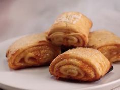 some food is on a white plate and it looks like they have been rolled up