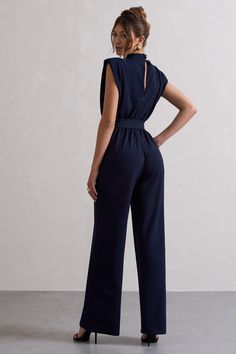 Simplistic yet sophisticated, Kalona is the ultimate staple for day to night dressing. Crafted in a rich navy hue, this straight-leg jumpsuit is detailed by subtle shoulder padding, button-closed high neckline and tied waist for a custom fit. For an elevated evening look, team yours with some complimenting gold accents and stilettos like Blade.Features - Premium stretch crepe- High neckline - Button-closed collar- Keyhole cut out- Shoulder padding- Invisible zip closure - Tie waist- Straight legSizing & Fit Model is 5'7" and wears UK size 8 / US size 4Product Information Designed exclusively by Club L London Lined with good stretch Premium crepe in Navy (95% Polyester, 5% Elastane) 84cm total inside leg length SKU: CL131064015 Navy Jumpsuit, Club L London, Jumpsuit Navy Blue, Office Attire, Stretch Crepe, Invisible Zip, Formal Attire, Good Stretches, Wide Leg Jumpsuit