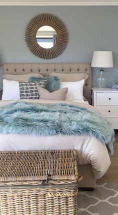 a bedroom with a large bed and wicker baskets on the floor next to it