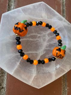 Spooky season is here and this beautiful bracelet is perfect to show off your spooky spirit Halloween Gift Bracelets With Round Beads, Spooky Orange Halloween Jewelry, Orange Beaded Bracelets For Halloween Gift, Spooky Halloween Bracelets For Gift, Spooky Halloween Gift Bracelets, Spooky Adjustable Bracelets For Halloween, Halloween Gift Stretch Bracelet With Round Beads, Beaded Bracelets For Halloween Gift, Handmade Beaded Bracelets For Halloween