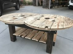 a table made out of wooden planks on the sidewalk