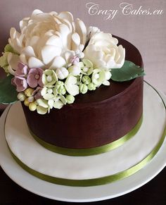 a chocolate cake with white flowers on top