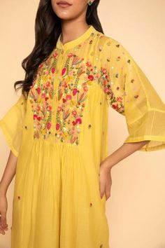 Yellow dress with floral embroidery around the neckline and mandarin collar. Comes with inner slip.
Component: 2
Embroidered
Neckline: Mandarin Collar
Sleeve Length: Three Quarter
Fabric: Chanderi Cotton
Color: Yellow
Front button placket - Aza Fashions Yellow Straight Kurta Dress With Intricate Embroidery, Straight Kurta With Multicolor Intricate Embroidery, Summer Anarkali Dress With Resham Embroidery, Festive Summer Kurta With Embroidered Hem, Elegant Embroidered Neckline Dress For Festivals, Elegant Dresses With Embroidered Neckline For Festivals, Festive Yellow Dresses With Floral Embroidery, Festive Yellow Embroidered Dress With Floral Details, Traditional Straight Kurta Dress With Embroidered Neckline