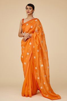 Orange saree in silk organza base with all over flora bloom pattern aari embroidery with sequins and zari. Paired with plunging sweetheart neckline sleeveless blouse and a petticoat.
Components: 3
Pattern: Embroidery
Type Of Work: Aari Work With Sequins and Zari
Neckline: Plunging Sweetheart Neckline
Sleeve Type: Sleeveless
Fabric: Saree: Silk Organza, Blouse: Chanderi, Petticoat: Poly Satin
Color: Orange
Other Details: 
Length:
Saree: 5.6-5.75inches
Petticoat: 39inches
Occasion: Wedding, Puja - Embroidered Saree Blouse, Organza Embroidery, Orange Saree, Organza Blouse, Saree Silk, Aari Embroidery, Beautiful Dress Designs, Pattern Embroidery, Satin Color