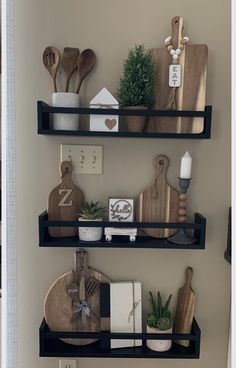 two shelves with wooden utensils and cutting boards on them