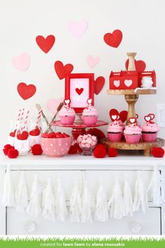 valentine's day dessert table with cupcakes and candy