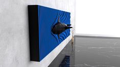 a black and blue wall hanging on the side of a white wall next to a marble floor