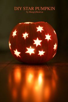 a pumpkin with white stars on it sitting on a table next to the words diy star pumpkin