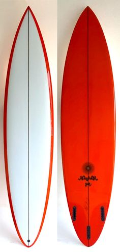 an orange and white surfboard sitting next to each other