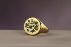 Embrace the timeless beauty of nature with this Engraved Flowers Bold Statement Round Signet Ring, a perfect expression of elegance and femininity. Designed for women who appreciate the delicate intricacies of floral designs, this ring features a round signet adorned with beautifully engraved flowers, making it an ideal gift for the nature-loving woman in your life. Crafted with care and precision, this piece combines the bold statement of a signet ring with the gentle allure of nature, offering Classic Round Birth Flower Jewelry, Elegant Gold Signet Ring With Birth Flower, Elegant Signet Ring With Birth Flower For Anniversary, Elegant Yellow Gold Engraved Ring With Birth Flower, Elegant Anniversary Signet Ring With Birth Flower, Nature-inspired Engraved Ring As A Gift, Gold Engraved Nature-inspired Rings, Nature-inspired Engraved Round Ring For Gift, Nature-inspired Engraved Ring For Gifts