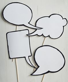 two white speech bubbles on sticks with black and white stickers