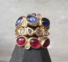 A gorgeous trio of rubies cabochons, the size of the stones are around 7x5mm, i have set them with 2 mm rose cut diamonds in the tones of cream and grays, beautifull combo, the entire ring is made of 18k yellow gold. Perfect to wear alone but can also be stack with your favorite bands. Made to order. Fine Jewelry Ruby Cluster Ring With Rose Cut Diamonds, Diamond Rings With Jeweled Details, Diamond Jeweled Rings, Jeweled Diamond Rings, Heirloom Ruby Ring With Gemstone Accents, Fine Jewelry Ruby Multi-stone Rings, Fine Jewelry Ruby Birthstone Ring With Rose Cut Diamonds, Jeweled Diamond Ring For Anniversary, Diamond Jeweled Rings For Anniversary