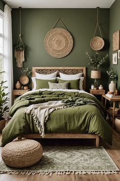 a bed with green sheets and pillows in a bedroom next to a large window filled with potted plants