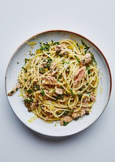 a white plate topped with pasta and meat