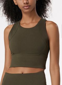 The EMES SHOP sports bra is detailed with a high round scoop neckline. thick tank straps. a built-in lined bra. and cropped fit. Features a thick waistband and acontouring seaming. This light-weight. quick-drying. buttery soft compressing sportsbra features all the support and comfort you need. while still looking cute.MATERIAL:75% Nylon. 25% Spandex MEASUREMENTS:Small : 4-6 Waist: 25-26.5 in Chest: 33-34.5 inMedium : 6-8 Waist: 26.5-28 in Chest: 34.5-36 inLarge : 8-10 Waist: 28-29.5 in Chest: 3 Stretch Sports Bra With Built-in Padding And Tank Straps, Fitted Tank Top With Built-in Padding, Racerback Crop Top With Built-in Padding For Yoga, Solid Color Sports Bra With Built-in Bra, Racerback, Sporty Racerback Crop Top With Built-in Bra, Stretch Tank Top With Built-in Padding And Scoop Neck, Solid Compression Tank Top With Built-in Padding, Versatile Solid Color Sleeveless Sports Bra, Compression Racerback Crop Top For Training