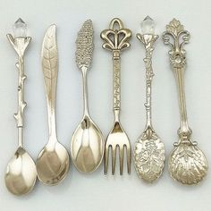 an assortment of antique silver spoons and forks