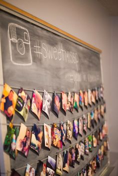 a chalkboard with pictures pinned to it