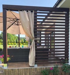 an outdoor living area with patio furniture and umbrellas