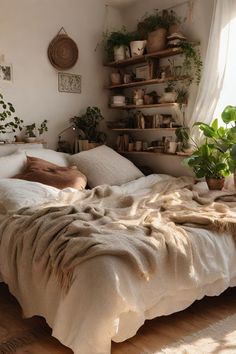 an unmade bed in a bedroom with plants and potted plants on the wall