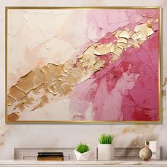 an abstract painting in gold and pink on a white wall above a fireplace mantel