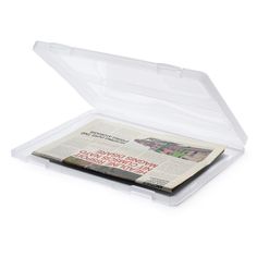 an open plastic box with a newspaper inside it on a white background, there is no image here to provide a caption for