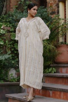 White kaftan featuring mirror embroidery along the neckline with golden stripes all over. - Aza Fashions White Mirror Work Kaftan For Festive Occasions, White Kaftan With Mirror Work For Eid, White Kaftan With Zari Work, Kaftan Women, White Kaftan, Mirror Embroidery, White Mirror, Bat Wings, Aza Fashion