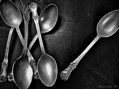 four spoons sitting next to each other on a table