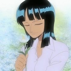 a woman with blue hair and white shirt holding a flower in front of her face