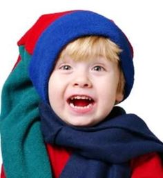 a young boy wearing a blue and green scarf with a red shirt underneath his arm