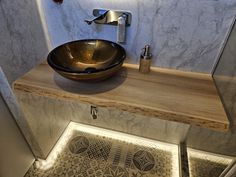 a bathroom sink sitting on top of a wooden counter