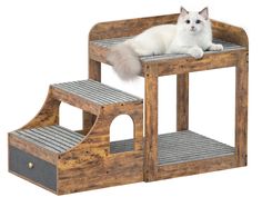 a white cat laying on top of a wooden step set with steps leading up to it