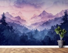 a wall mural with mountains and trees in the background