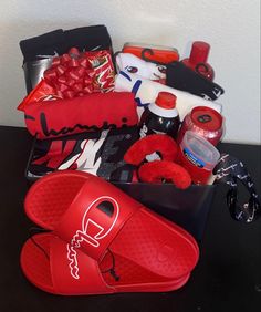 a pair of red slippers sitting on top of a table next to other items