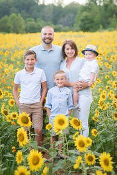 a family standing in a sunflower field