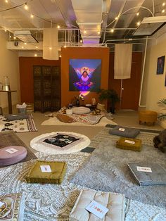 a room filled with lots of different types of pillows and rugs on the floor