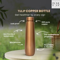 a copper colored stainless steel bottle with instructions on how to put it in the cup