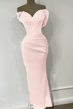 a mannequin with a pink dress on display in front of a white wall