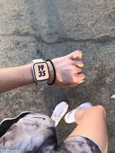 a person wearing a wrist watch with the number twenty five printed on it's side