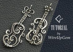 the earrings are made out of silver wire and have intricate designs on them, as well as