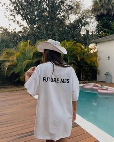 a woman wearing a white t - shirt that says future mrs in black on it