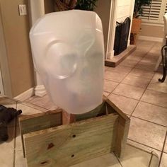 a large white plastic head in a wooden box