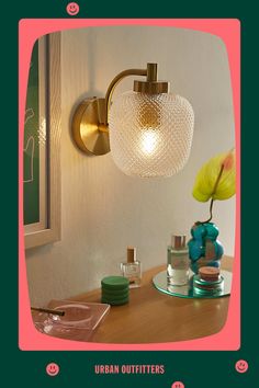 an image of a bathroom vanity light with flowers on the counter and mirror behind it