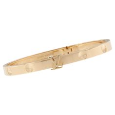 This Louis Vuitton Empreinte bangle in 18-carat yellow gold features the trunk-nail imprints, a timeless House signature. The iconic LV Initials join here the collection and serve as a clasp for this strong hinged bracelet. The Empreinte bangle can be worn stacked on the arm with other bracelets, for a stylish, modern look. Pre Order ONLY through LV and a 3-5 month wait period or you can have it now! Complimentary signature wrapping included. 18KYG Size 16 Timeless House, 18k Gold Bangle, Louis Vuitton Bracelet, French Yellow, Bangle Box, Louis Vuitton Empreinte, Yellow Gold Bangle, Louis Vuitton Jewelry, Hinged Bracelet