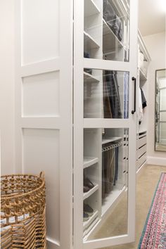 an organized closet with white shelves and drawers