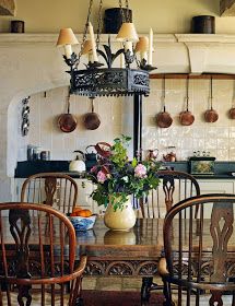 a dining room table with chairs and a potted plant on top of the table