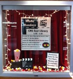 a display case with popcorn and movie memorabilia