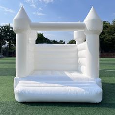 an inflatable bed sitting on top of a green field