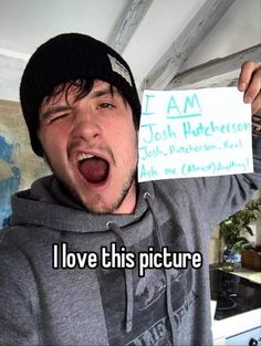 a man holding up a sign with the words i love this picture in front of him