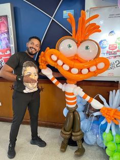 a man standing next to an inflatable cartoon character